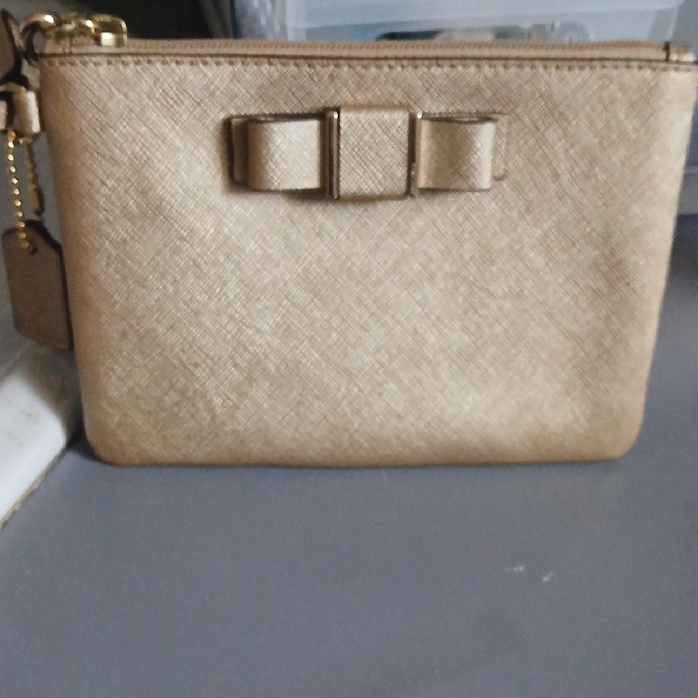Coach Darcy Bow Wristlet in metallic gold Saffiano leather with a decorative bow